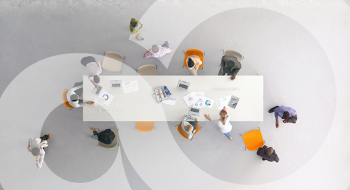 Colleagues having a meeting at a large conference table