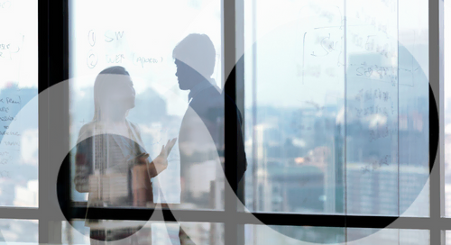 Two business people chatting in a conference room